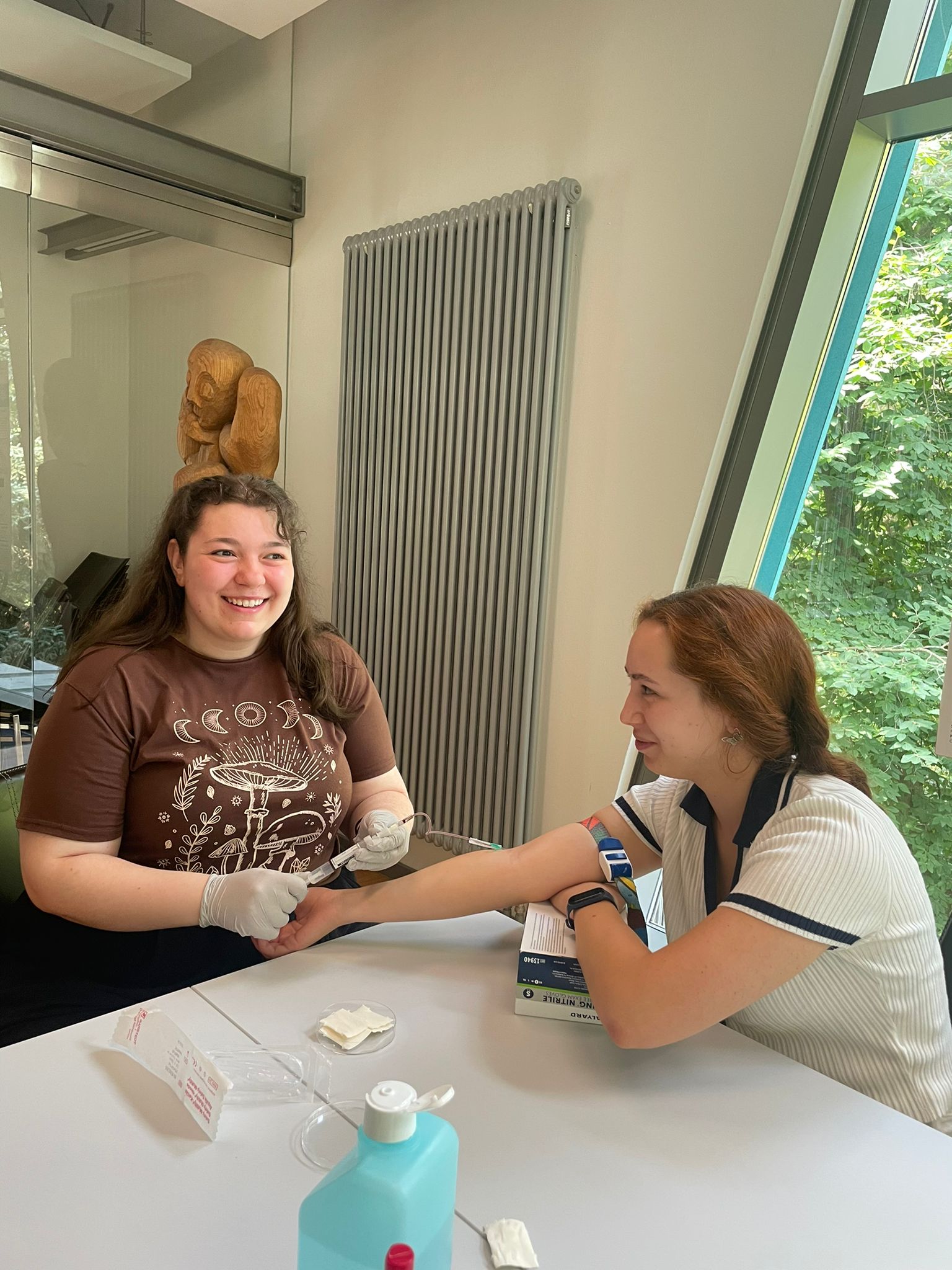 Two students taking each others blood.