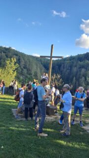 Hike break at the cross on the top of a mountain.