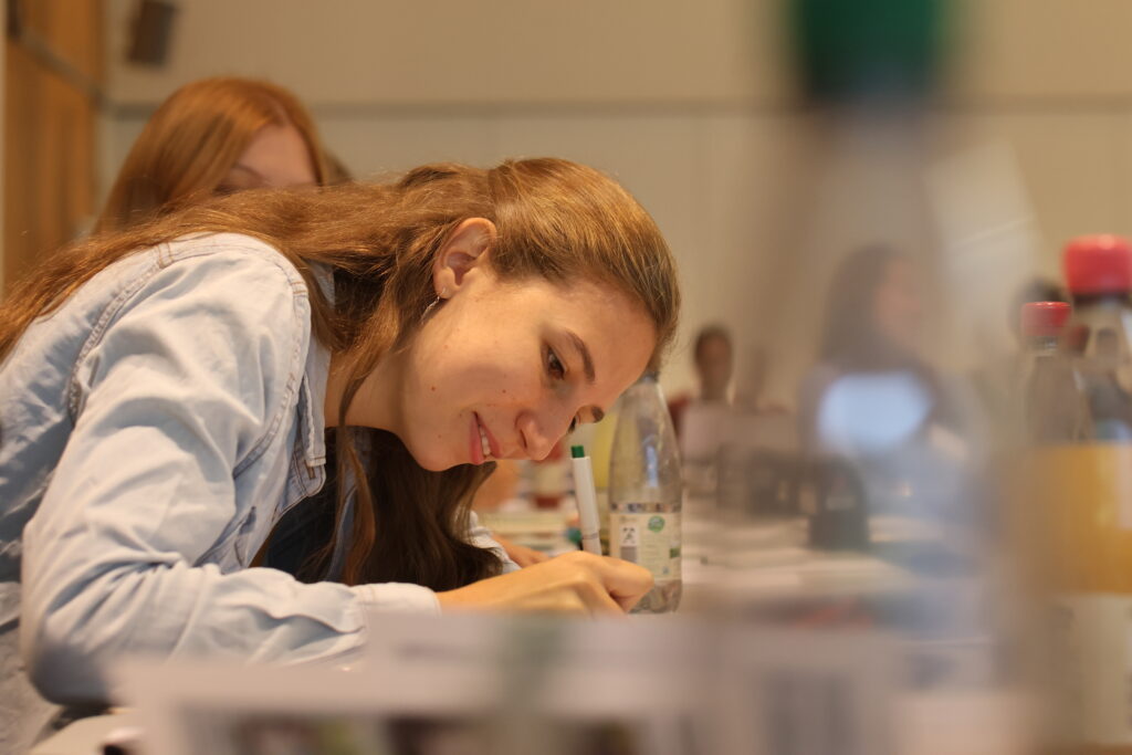 Student taking notes during a presentation.